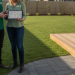 Landscaper discussing the cost of landscaping in Moncrieff with a homeowner beside a freshly planted garden bed