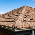 Cracked mortar pointing on ridge capping tiles, showing why roof maintenance Wanniassa homeowners need before winter